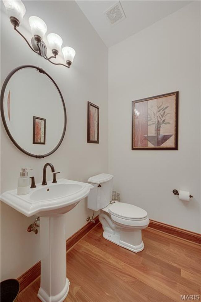 Half bathroom with baseboards and wood finished floors | Image 40