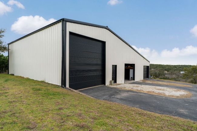 RV space, pull through middle garage doors, workshop area, plus office | Image 31