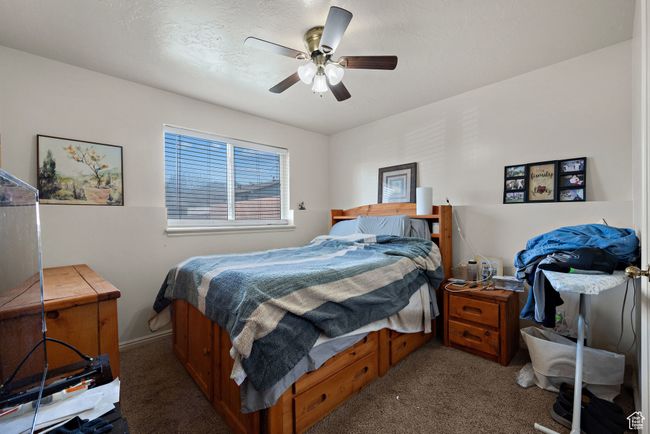 Carpeted bedroom featuring ceiling fan | Image 52