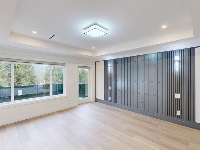 Empty room featuring a tray ceiling, wood finished floors, and recessed lighting | Image 33