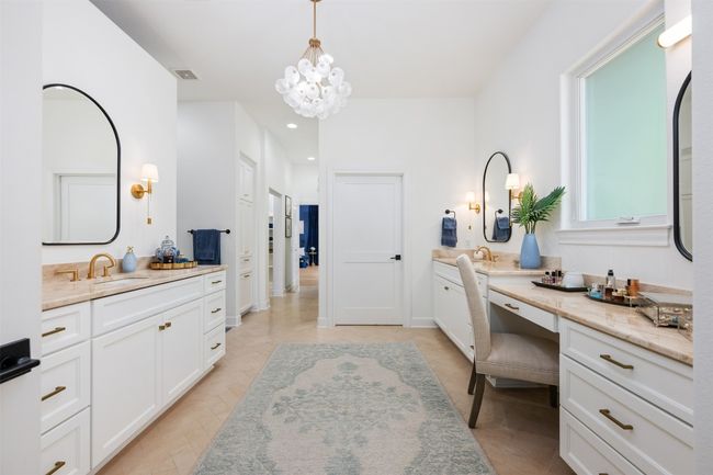 Primary en suite featuring two vanities, recessed lighting, and a chandelier. Simply gorgeous! | Image 13