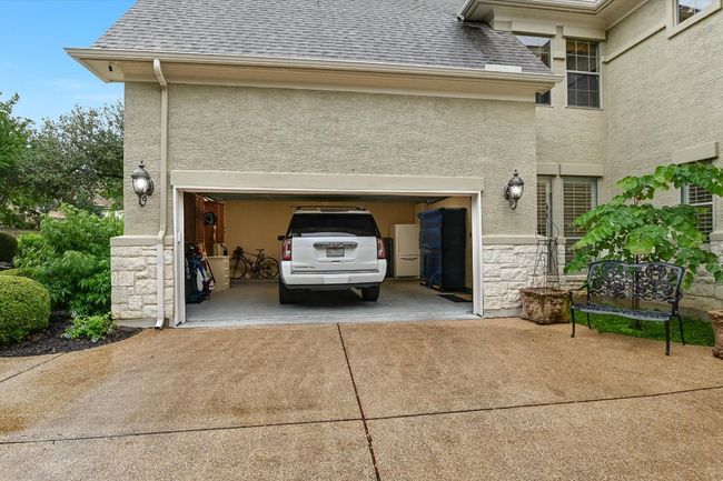 Garage with driveway, wood garage doors, and spacious enough for large vehicles. | Image 39