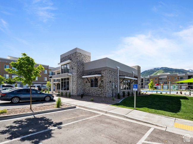 View of building exterior featuring a mountain view and uncovered parking | Image 16