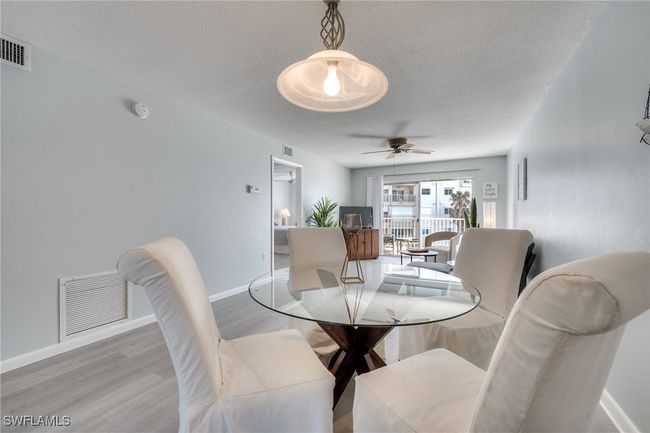 Dining space featuring ceiling fan, a textured ceiling, and light wood-type flooring | Image 21