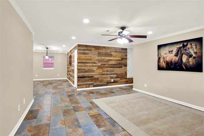 view of living room and dining from front door | Image 8