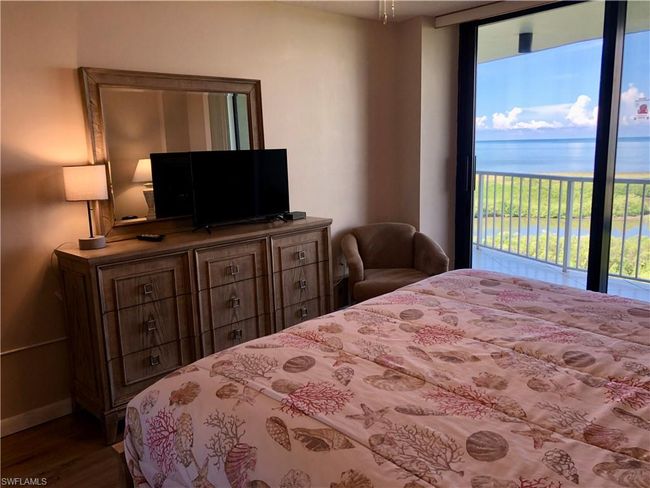 Bedroom featuring access to outside and wood finished floors | Image 14