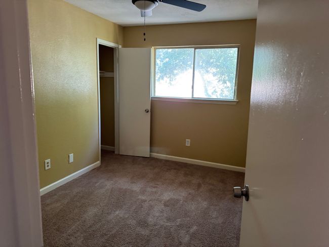 Unfurnished bedroom with carpet floors and ceiling fan | Image 13
