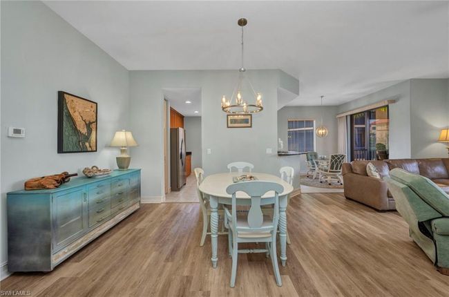 Dining area featuring a chandelier and light wood-style flooring | Image 7