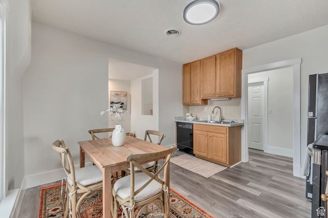 Dining space featuring visible vents, light wood-style flooring, and baseboards | Image 11