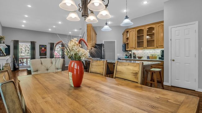 Dining space featuring recessed lighting, an inviting chandelier, and wood finished floors | Image 9