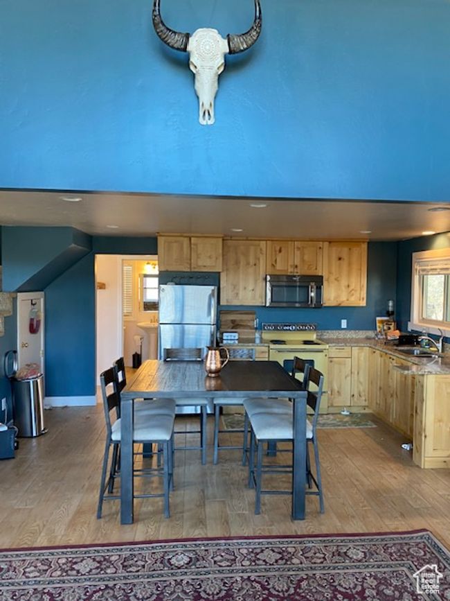 Dining space with hardwood / wood-style floors and baseboards | Image 6