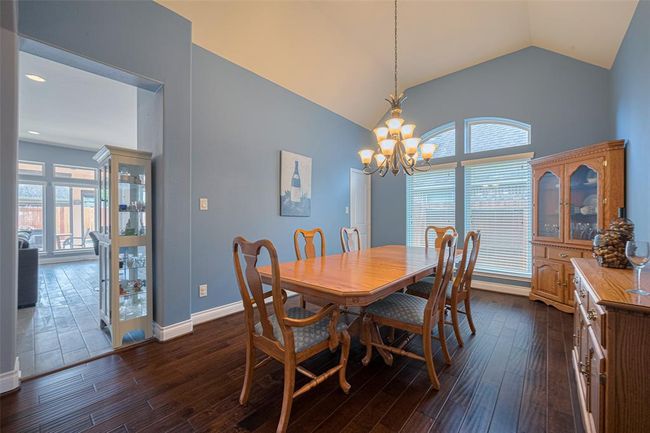 Dine in uncrowded comfort in this oversize Dining Room with wood floors. | Image 10