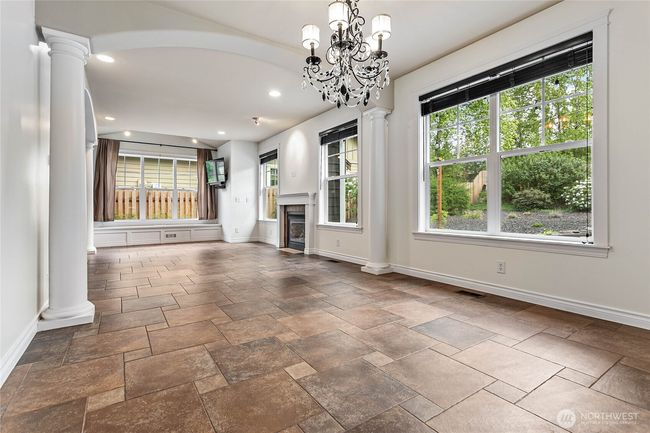 Oversized dining room leads into a spacious living room. | Image 10
