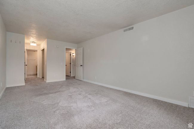 Empty room featuring light carpet and a textured ceiling | Image 12