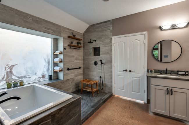Full bathroom featuring vaulted ceiling, a walk in shower, vanity, and a garden tub | Image 29