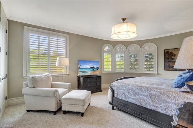 Carpeted bedroom with ornamental molding and baseboards | Image 11