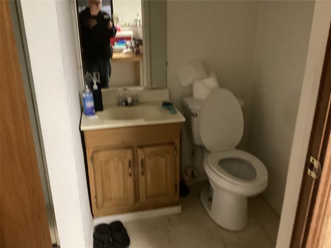 Half bath with vanity, tile patterned floors, and toilet | Image 12