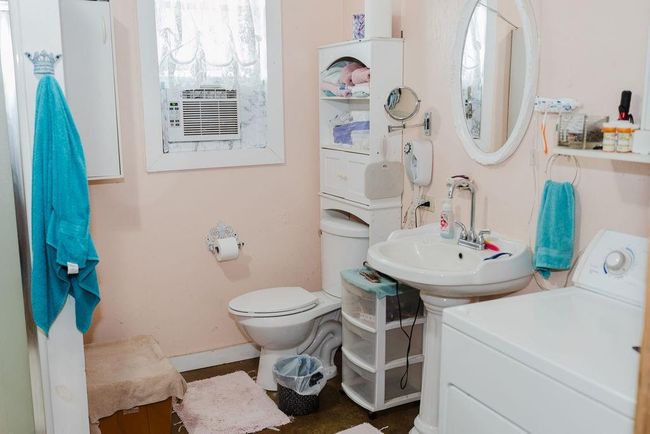 Bathroom featuring washer / dryer and toilet | Image 15