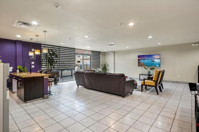 Living room with light tile patterned flooring and recessed lighting | Image 15