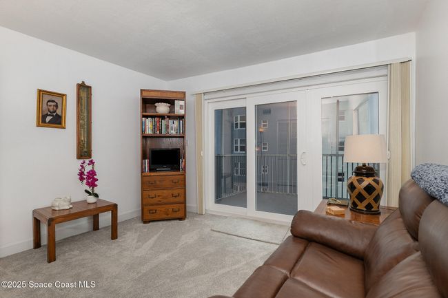 Guest bedroom used as a tv room with separate balcony | Image 25