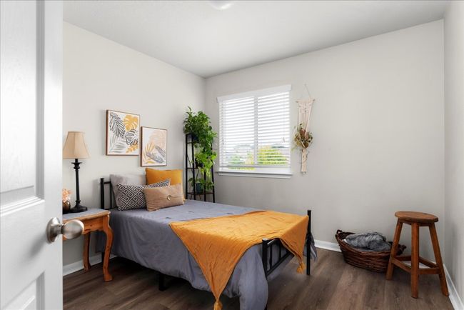 Bedroom featuring wood finished floors and baseboards | Image 22