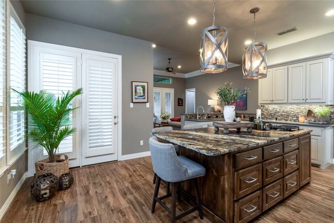 Kitchen island featuring a breakfast bar | Image 11