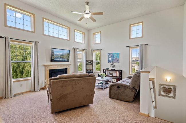 Living room has high ceilings, tons of natural light and gas fireplace. | Image 4