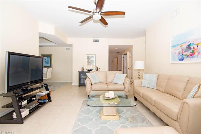 Spacious living room tastefully appointed with leather furnishings. | Image 5