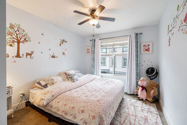 Bedroom featuring light carpet, baseboards, and a ceiling fan | Image 21