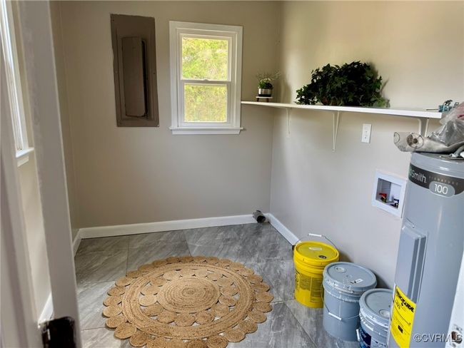 Laundry area with hookup for a washing machine, water heater, baseboards, and electric panel | Image 20