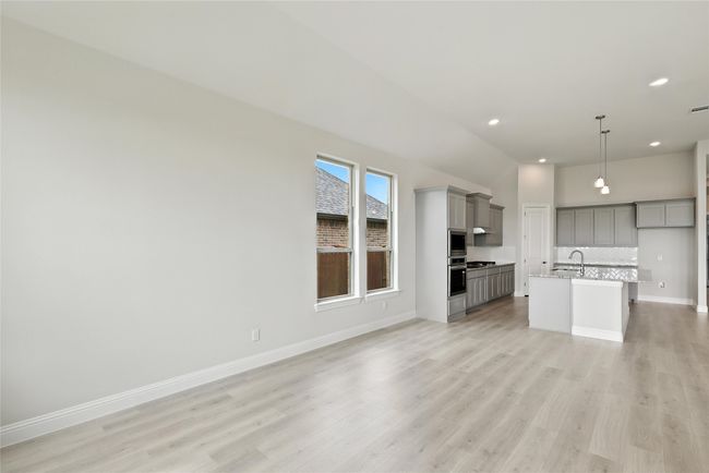 Unfurnished living room with light wood-type flooring and recessed lighting | Image 9