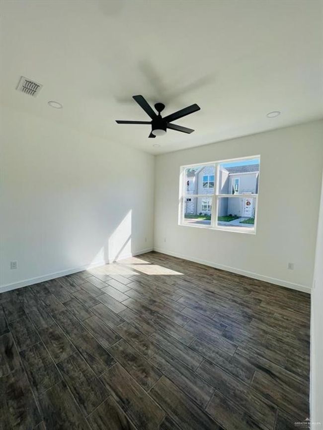 Spare room with dark hardwood / wood-style floors and ceiling fan | Image 20