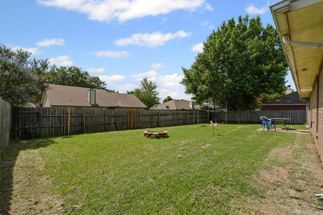 View of fenced backyard | Image 26