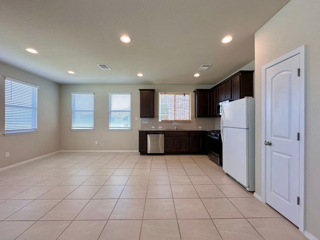 Kitchen featuring freestanding refrigerator, dishwasher, range with gas cooktop, healthy amount of natural light, and recessed lighting | Image 7