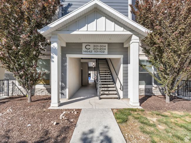 Doorway to property featuring board and batten siding and fence | Image 19