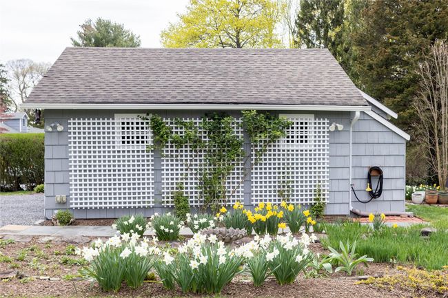 Detached 2 car garage with trellis and attached storage sheds | Image 4