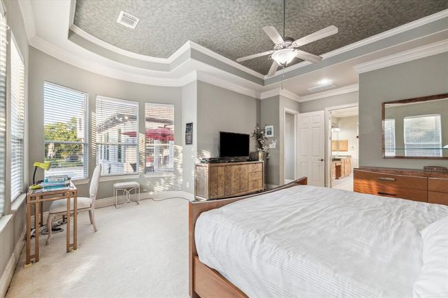Alternate angle of the Primary Retreat shows the sitting area that features bay windows overlooking the pool. | Image 17
