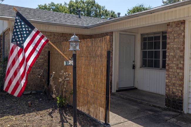 Property entrance featuring a shingled roof and brick siding | Image 14