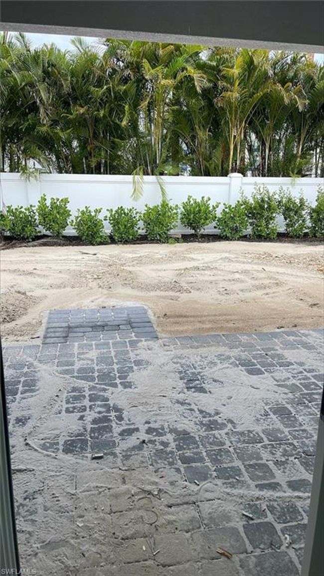 Backyard view of covered lanai with pavers | Image 22