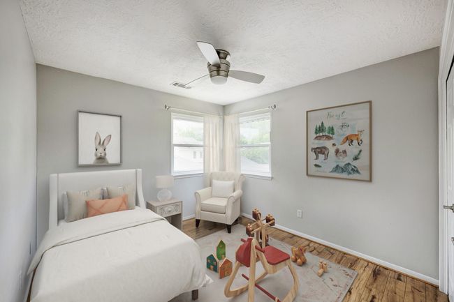 One of three secondary bedrooms located upstairs. Photo is virtually furnished. | Image 12