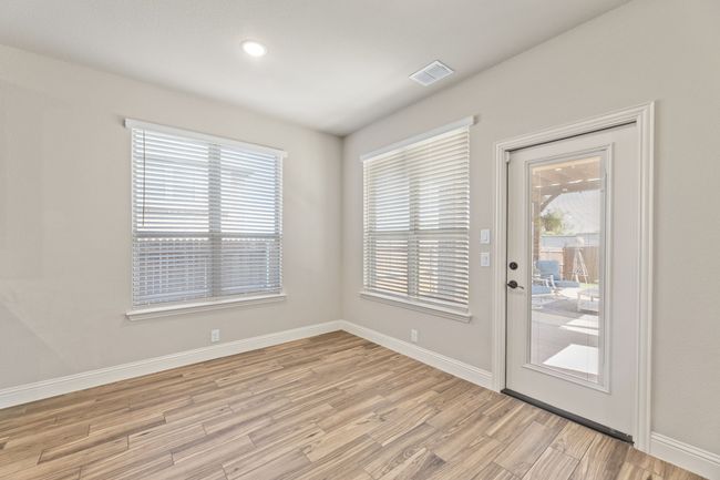 Doorway featuring light wood-type tile flooring and healthy amount of natural light. Door leading to covered patio. | Image 20