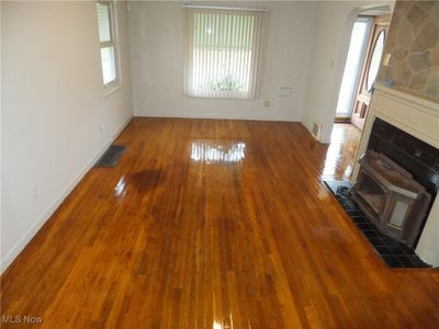 Unfurnished living room with hardwood / wood-style flooring | Image 3