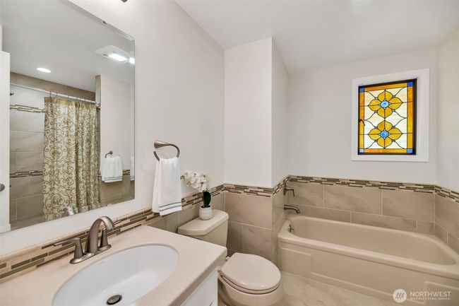 Updated primary four- piece bath with big walk-in shower and separate bathtub | Image 23