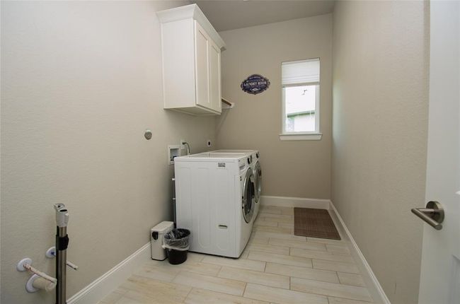 Large laundry room with plumbing for a sink and room for a extra fridge or freezer. | Image 22