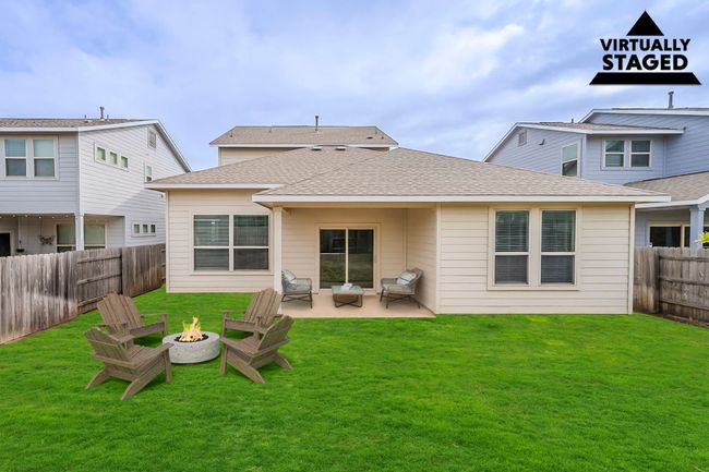 Back of house with an outdoor fire pit, a patio, and a shingled roof | Image 33