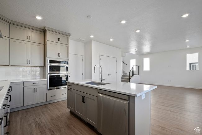 **The heart of the home—**this open-concept kitchen and living area makes gathering effortless, from busy weekday mornings to relaxed weekend dinners. | Image 9