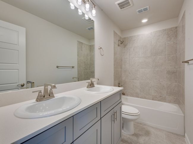 Guests will enjoy their own vanity space in this thoughtfully designed and beautifully finished guest bath. | Image 15
