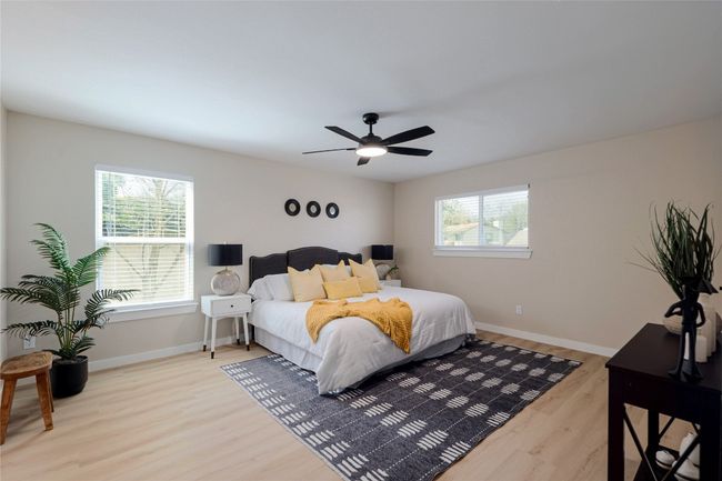 Bedroom with baseboards, wood finished floors, and a ceiling fan | Image 12