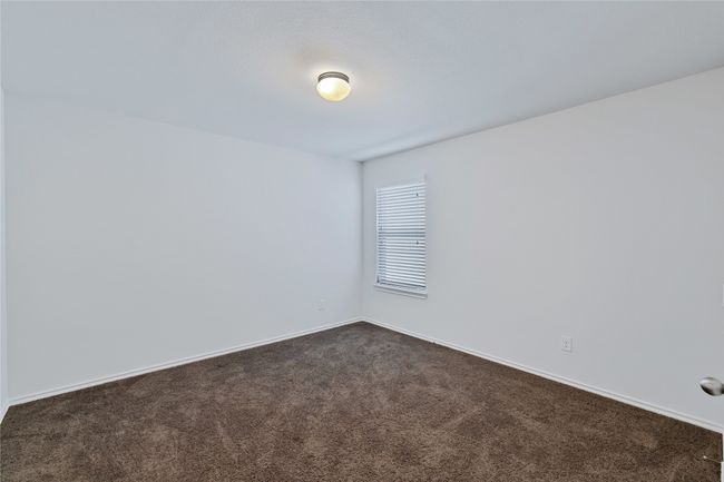 Unfurnished room featuring dark carpet | Image 27