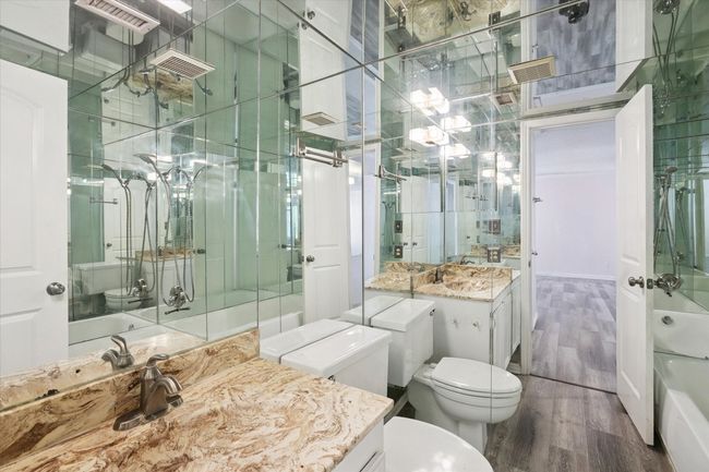 Full bath with wood finished floors and vanity | Image 11